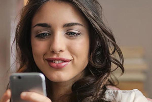woman looking at mobile app on cell phone